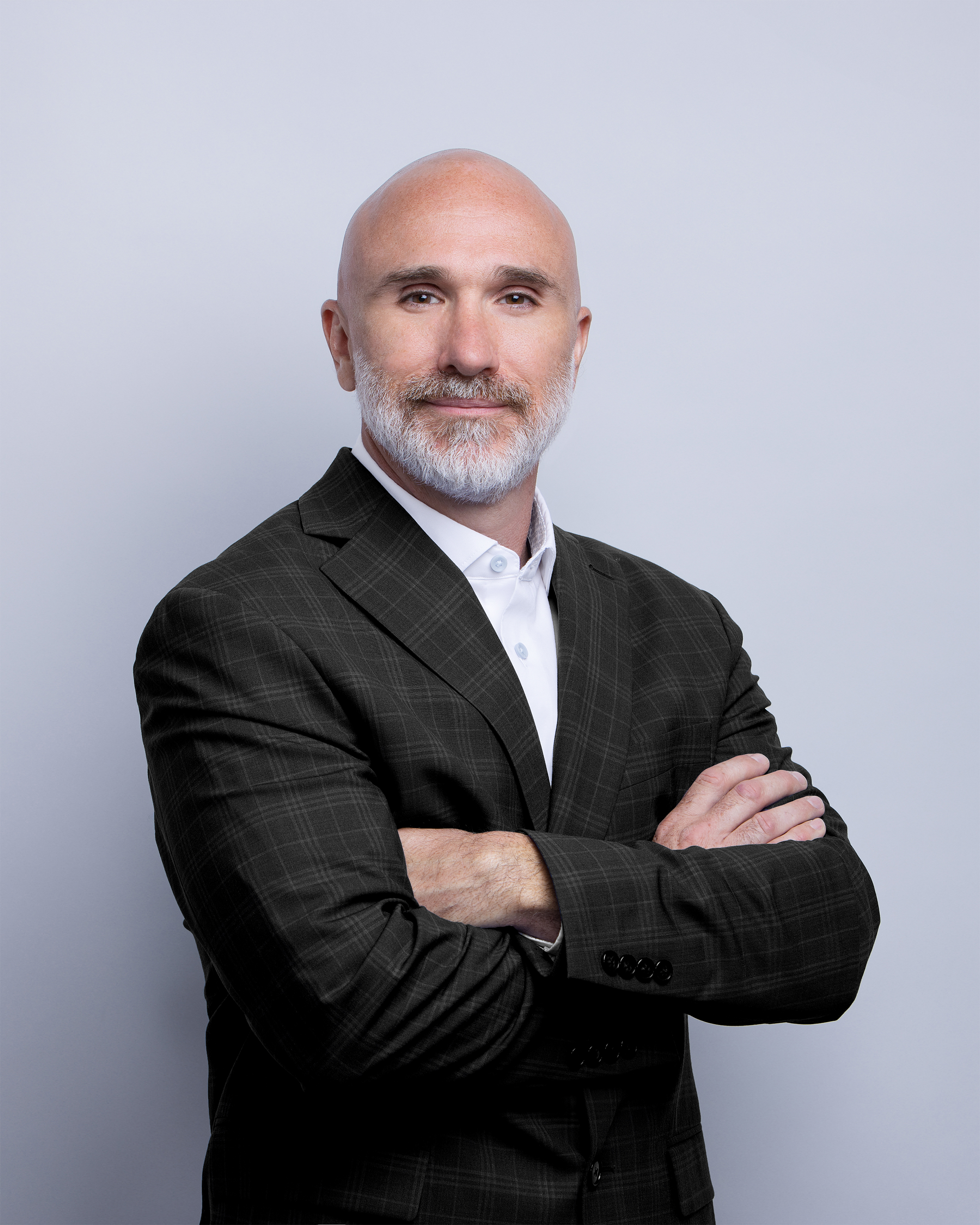 A man in nice jacket with his arms crossed.