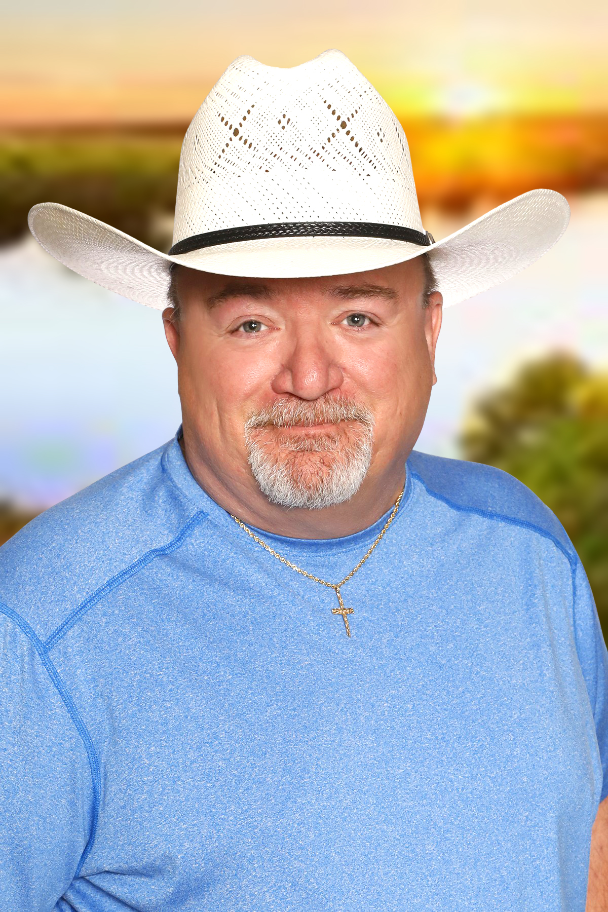 A man in a hat smiling.