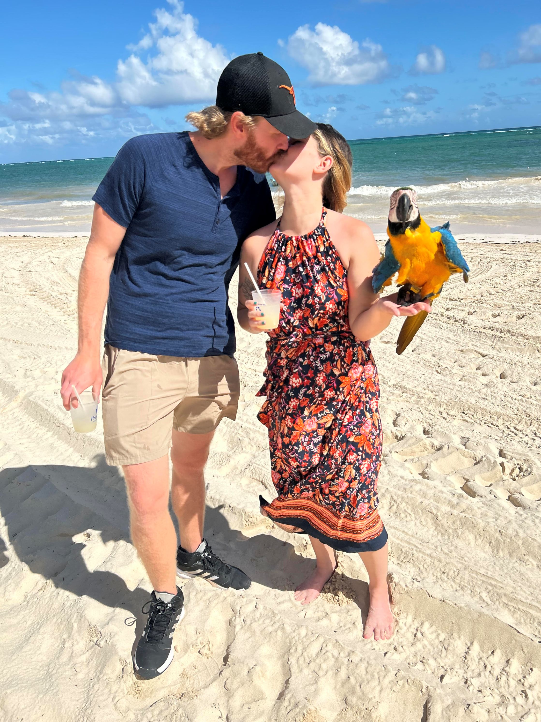 Professional headshot of a smiling man with short black hair and a beard, dressed in a blue blazer and patterned shirt, in a modern interior with decorative elements.